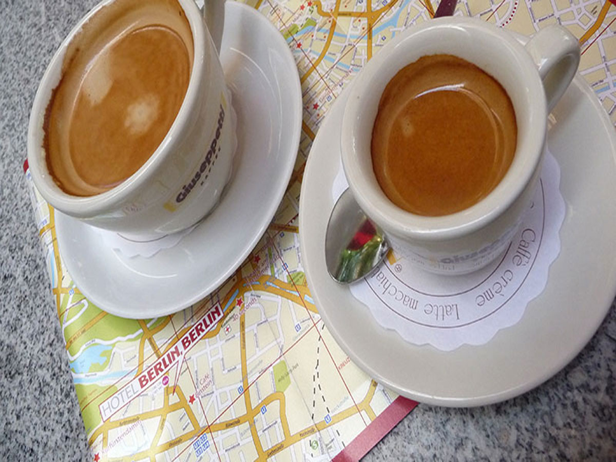 Map of Berlin with 2 espresso coffees sitting on top of it