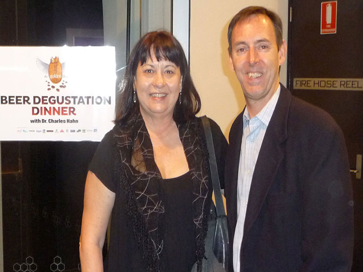 Paul Holiday & Christine Cottrell with sign 'Beer Degustation Dinner' at Golden Bean Roasting Competition