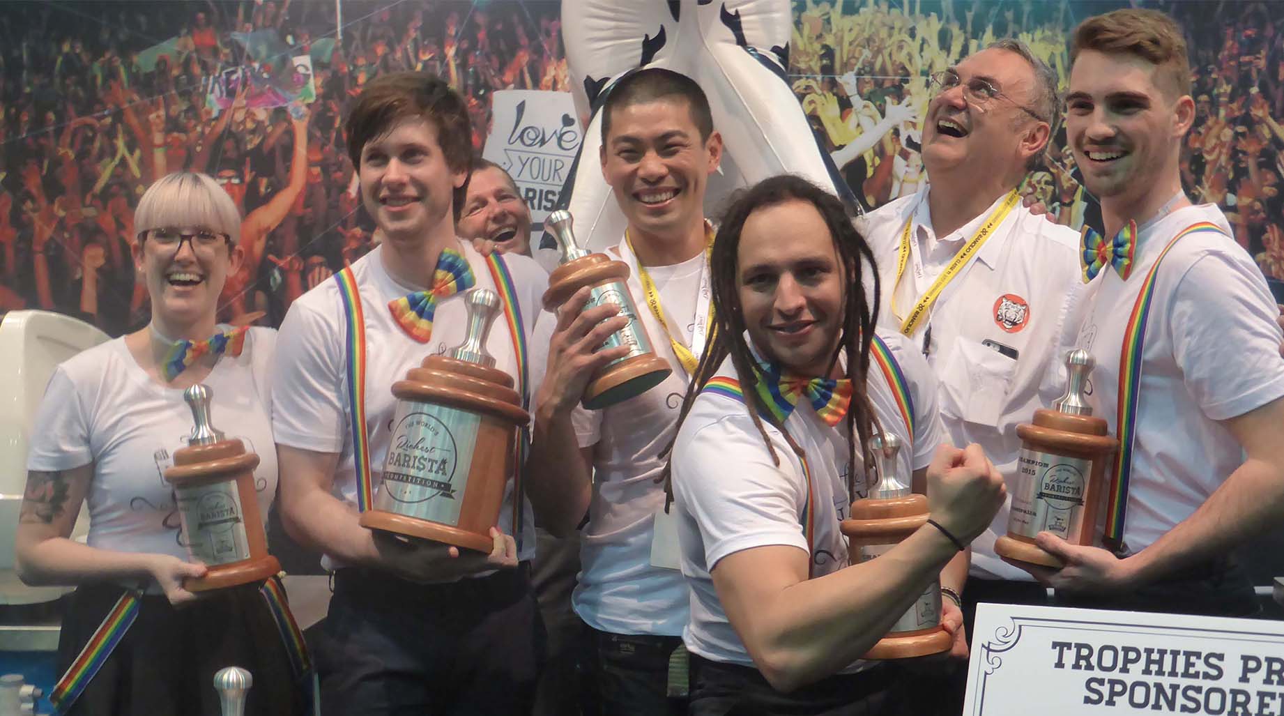 A group of 6 people with trophies
